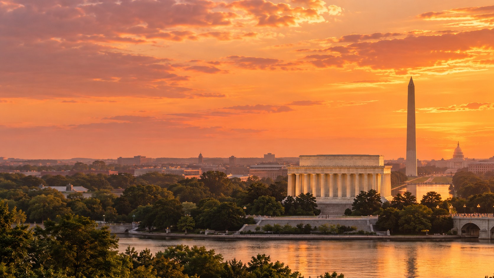 Dreamy amber sunset over the Lincoln Memorial, with the Washington Monument beyond and warm reflections on the Potomac
